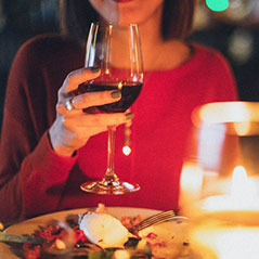 woman drinking wine with dinner
